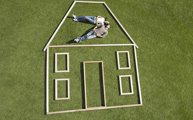 New Homeowners Lying In The Grass