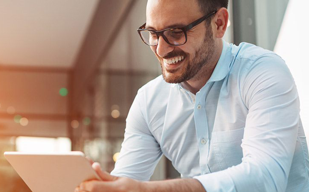 Man With Glasses Using Computer. 