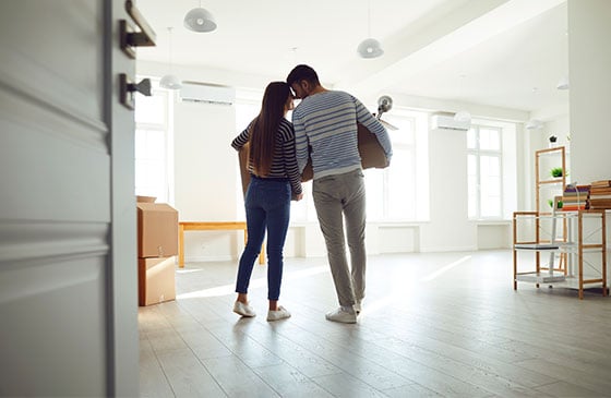 Young couple inside a house after purchasing first home