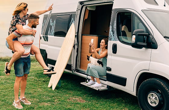 Couple taking photo near new camper van