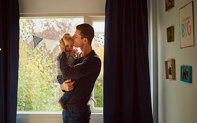 Father and son standing in the child's bedroom. 