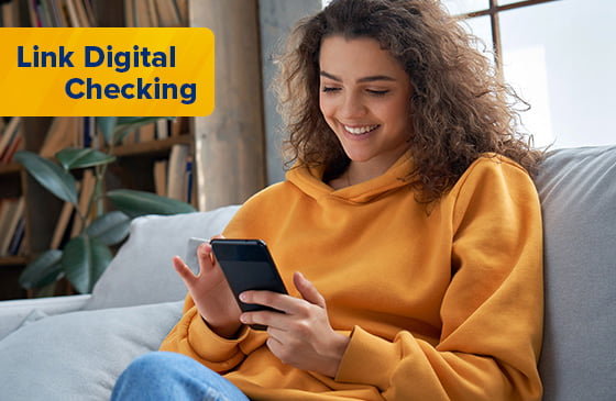 Young women accessing checking account from couch