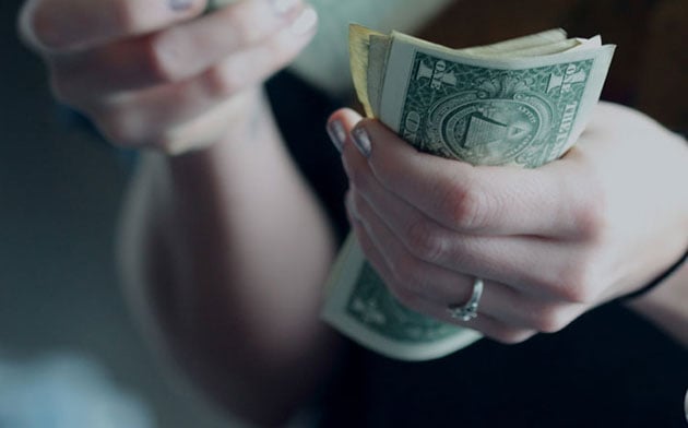 Person counting money. 