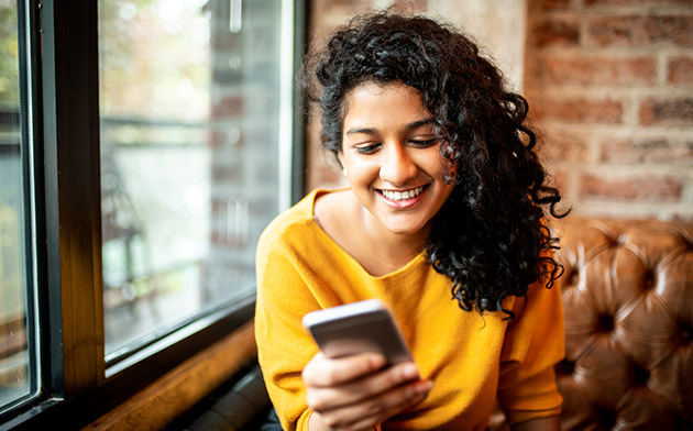 Woman smiling looking at phone