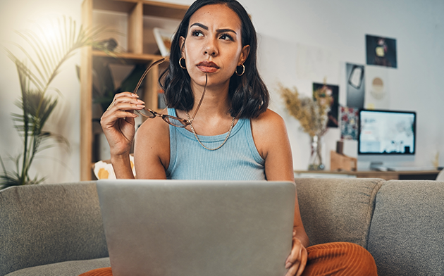 Woman thinking while on laptop