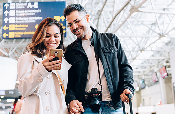 Couple on a holiday vacation using credit card