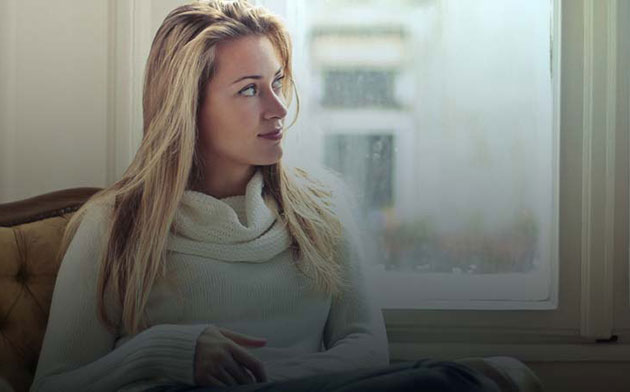 Woman sitting on her couch. 