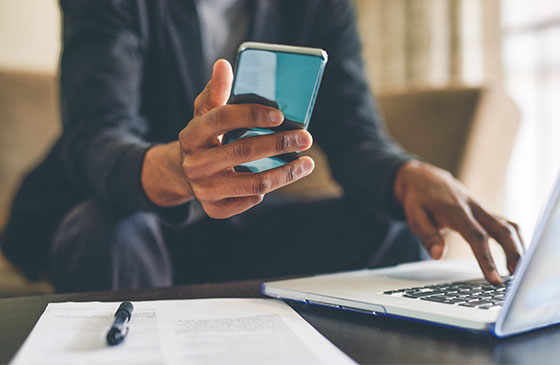 Person using phone to access online account materials