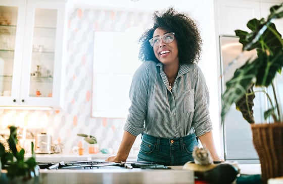 Professional woman standing with her hands on desk