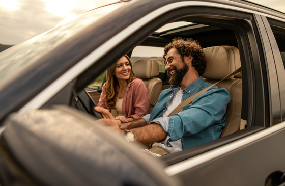 Two people test driving a new car