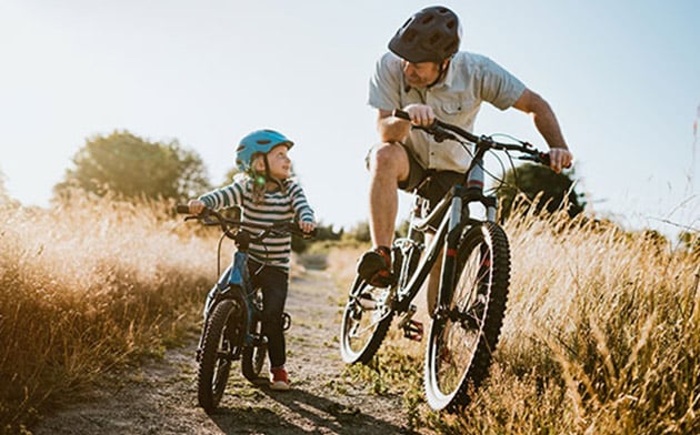 Dad and daughter riding bikes