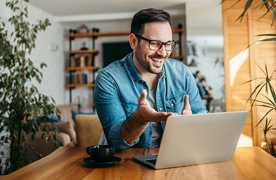 Man on computer talking to a virtual credit union rep