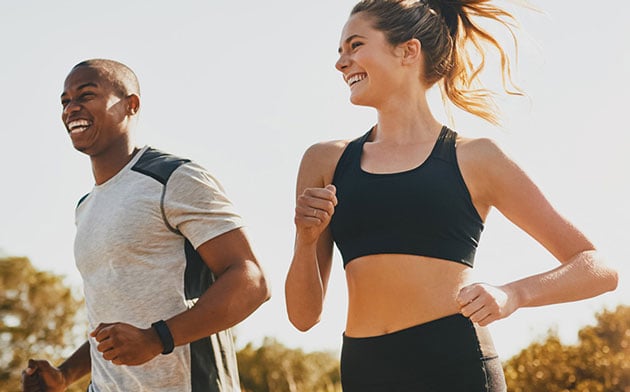 A couple running together outside