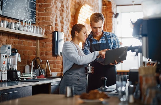 Man and woman looking at laptop