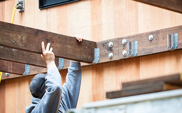 Contractor putting up wooden beams