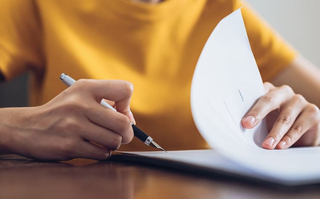 Business owner signing loan paperwork