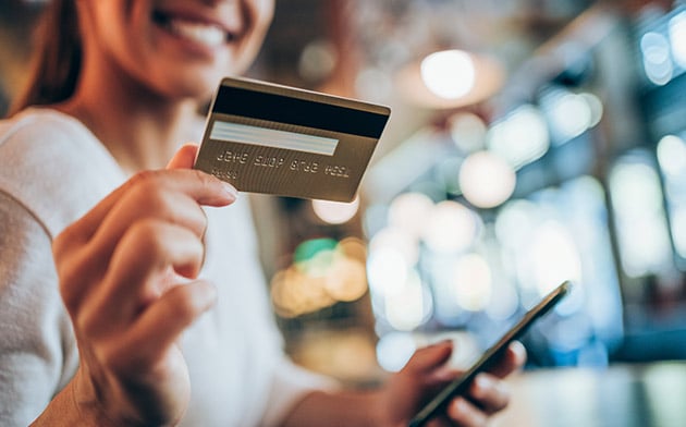 Woman with credit card and phone