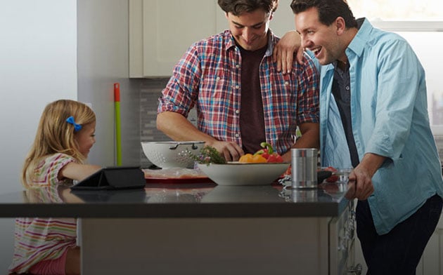 Couple with their daughter in the kitchen. 