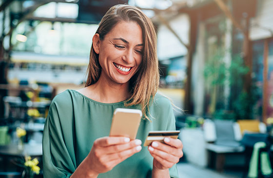 Young woman with phone and credit card