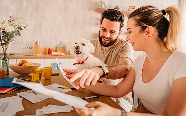 Couple with dog filling out paperwork