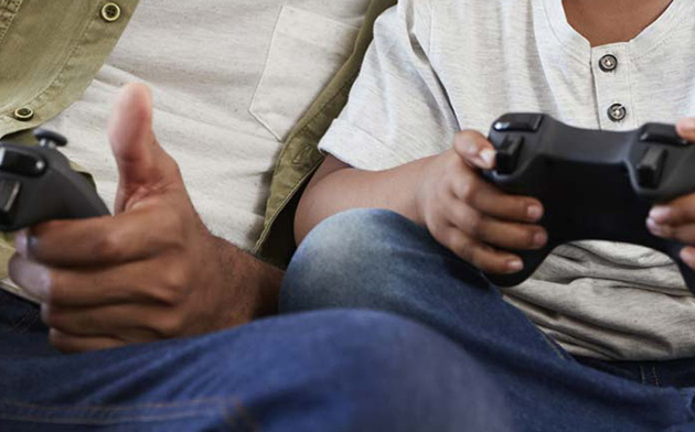 Dad and son play video games