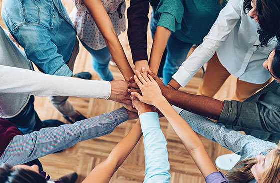 People joining hands in a circle