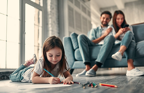 Family sitting together in the living room shopping insurance 