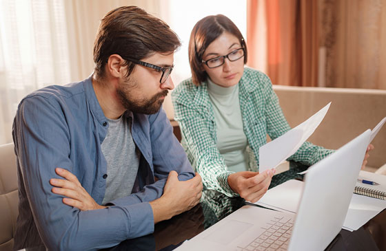 Couple looking a student loan documents 