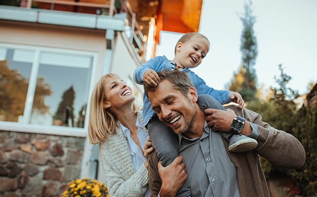 Family in front of house