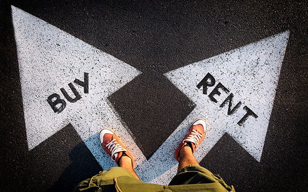 A person standing at a buy vs. rent crossroads.