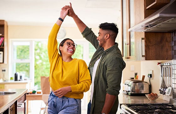 Two people dancing in their new home. 