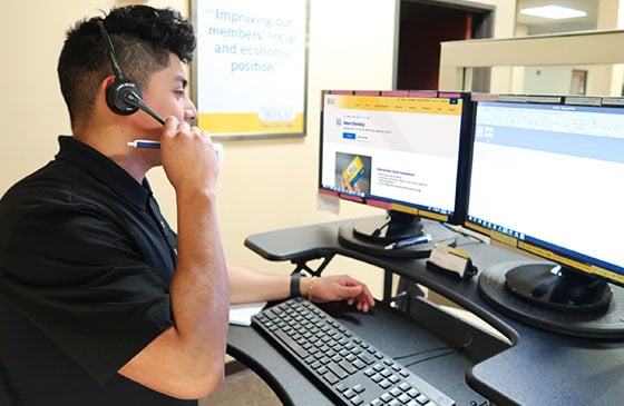 SELCO Community Credit Union team member working on computer