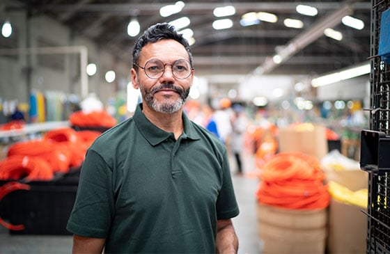 Large enterprise business owner standing inside production facility