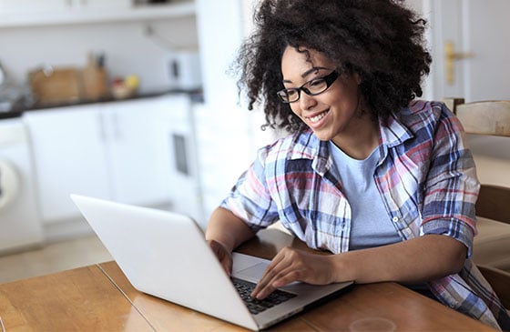 Women with glasses using laptop