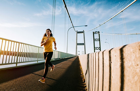 Women with yellow shirt on running outside