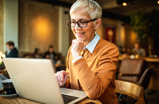Bespectacled woman on laptop