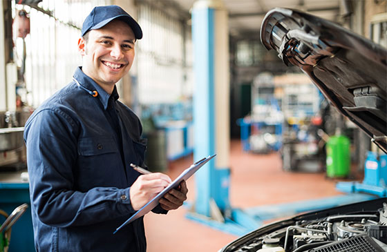 Mechanic inspecting car engine