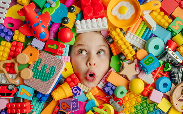 Child surrounded by toys