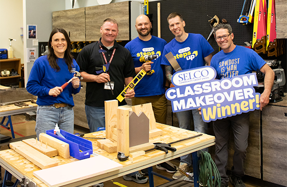 SELCO and Obsidian Middle School staff standing in the middle of the new classroom makeover.