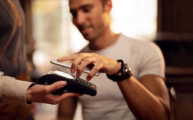 Man using his phone to pay.