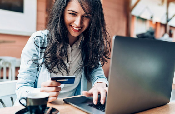 Women using a credit card to make online purchase
