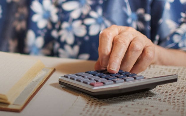 Older woman using a calculator.
