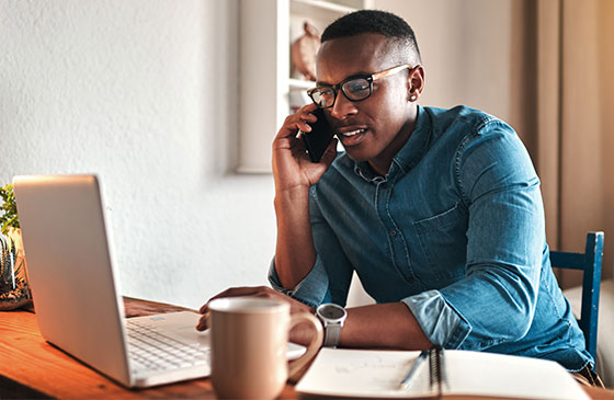 Man using phone banking from home