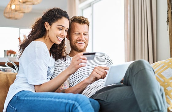 Couple admires their platinum credit card.